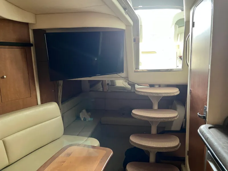 Slide: The Image of Interior of 2006 Sea Ray 340 Sundancer with TV, seating, and stairs. - 19
