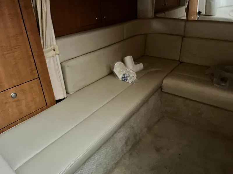 Slide: The Image of Interior of 2006 Sea Ray 340 Sundancer with beige seating and wooden cabinetry. - 20