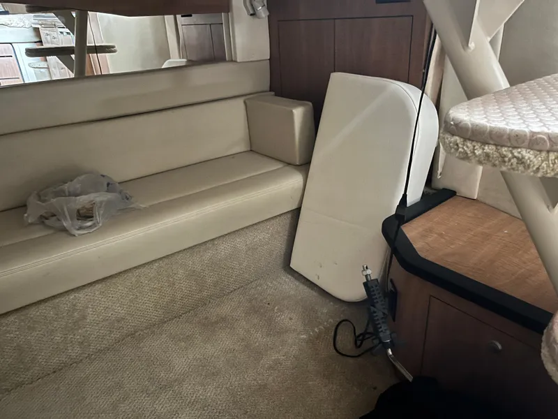 Slide: The Image of Interior of a 2006 Sea Ray 340 Sundancer with beige seating and carpet. - 21
