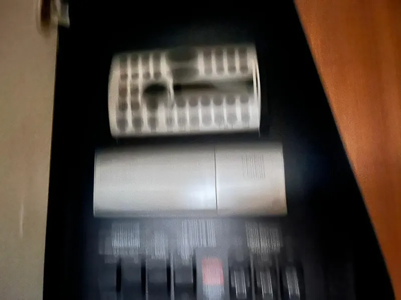 Slide: The Image of Control panel of a 2006 Sea Ray 340 Sundancer boat, featuring switches and a remote. - 24