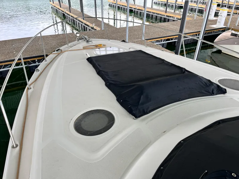 Slide: The Image of 2006 Sea Ray 340 Sundancer boat docked, featuring a spacious deck and sleek design. - 29