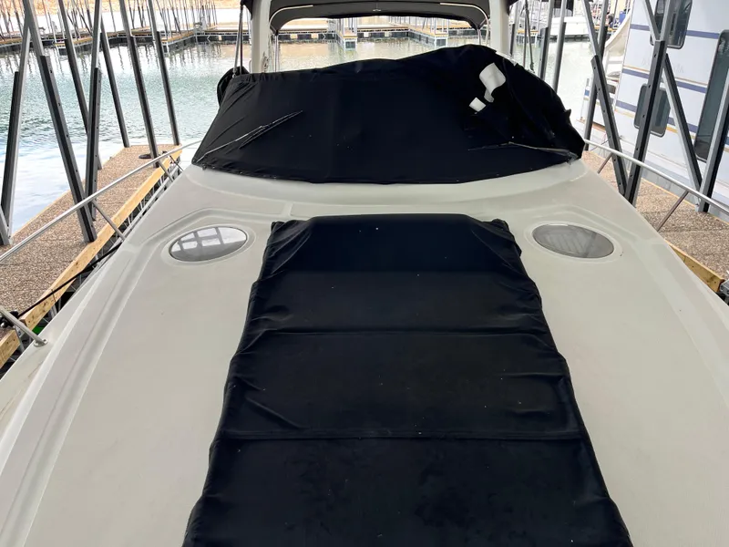 Slide: The Image of 2006 Sea Ray 340 Sundancer boat with black cover on deck, docked in marina. - 31