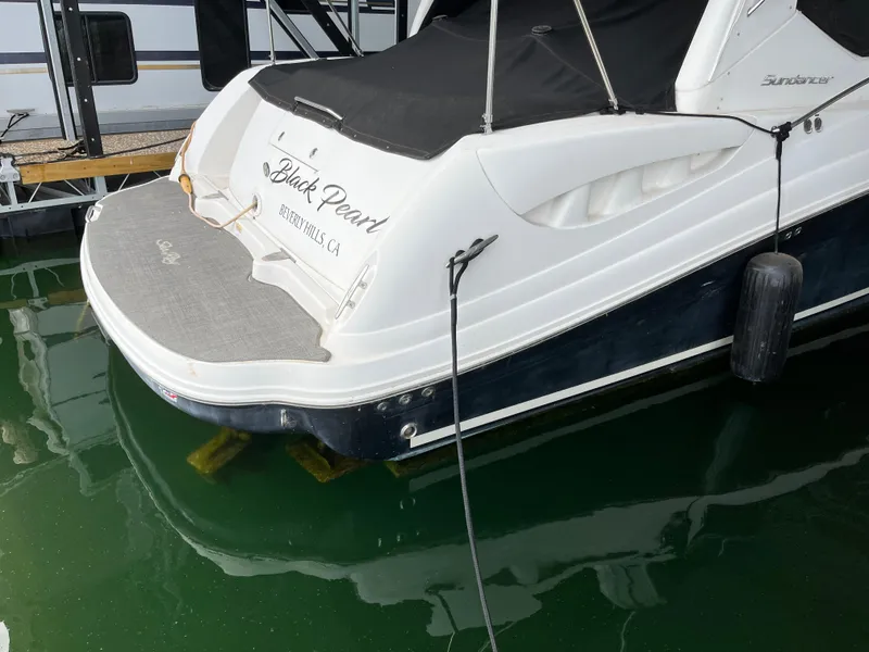 Slide: The Image of 2006 Sea Ray 340 Sundancer docked, rear view with "Black Pearl" name visible. - 5