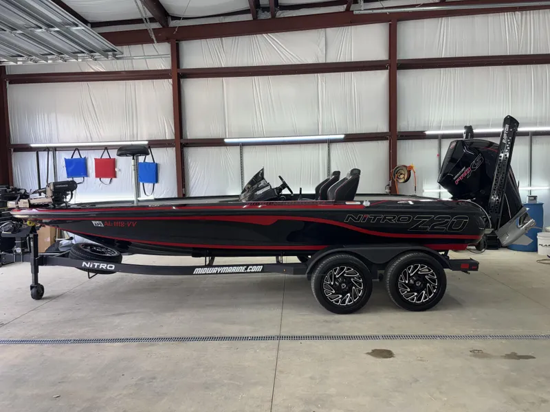 Slide: The Image of 2024 Nitro Z20 Pro boat in a garage, featuring sleek black and red design. - 1