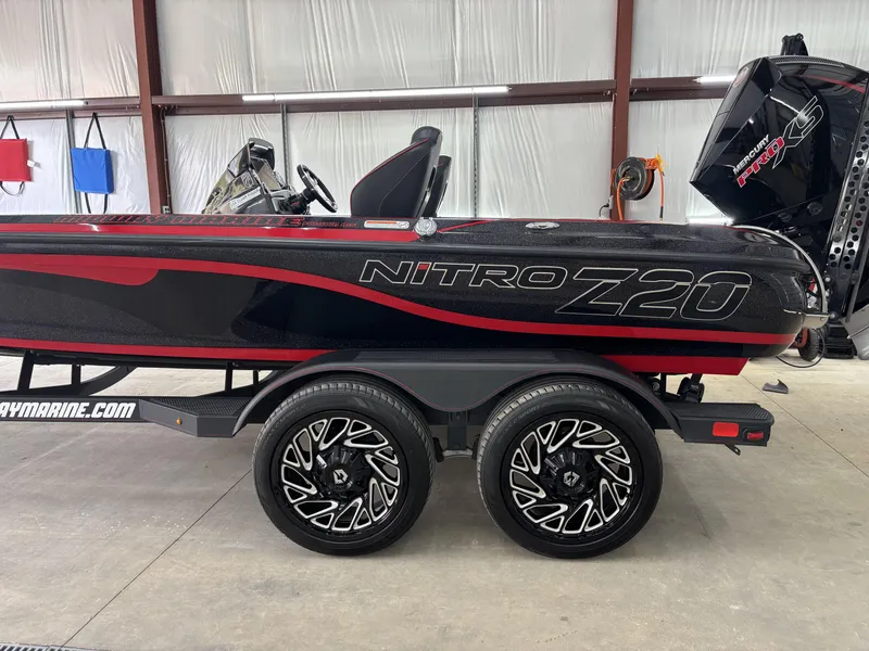 Slide: The Image of 2024 Nitro Z20 Pro boat with sleek black and red design in a garage setting. - 10