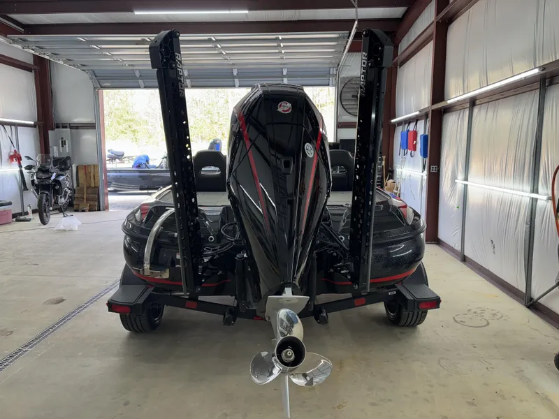 Slide: The Image of 2024 Nitro Z20 Pro boat in garage, rear view with motor and propeller visible. - 12