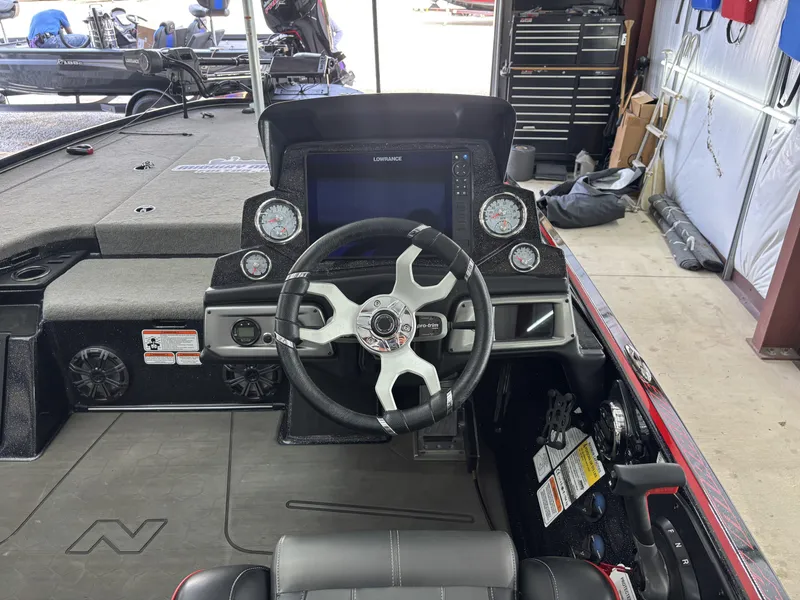 Slide: The Image of 2024 Nitro Z20 Pro boat cockpit with steering wheel, gauges, and control panel. - 14