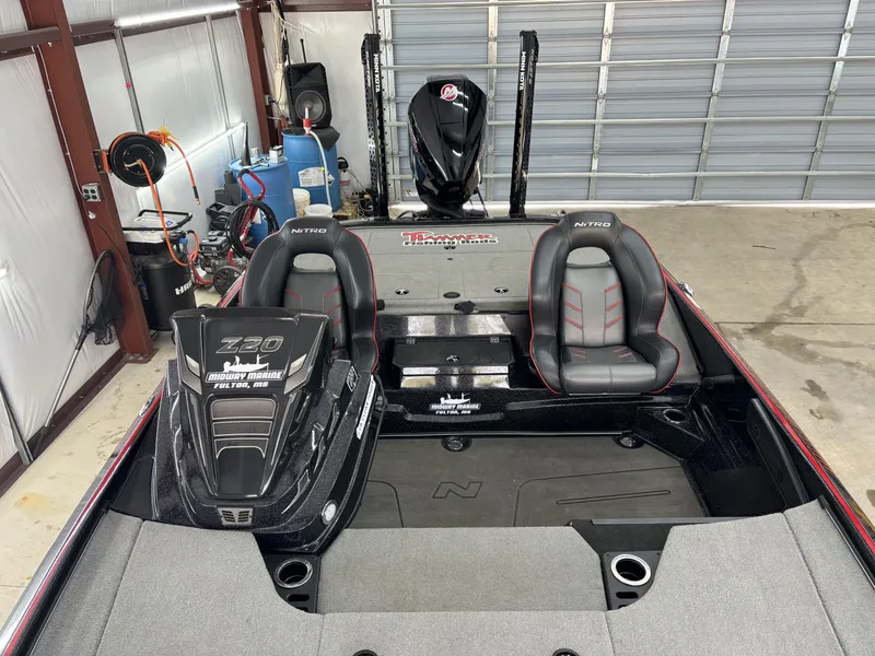 Slide: The Image of 2024 Nitro Z20 Pro boat interior with dual seats and storage compartments in a garage. - 16