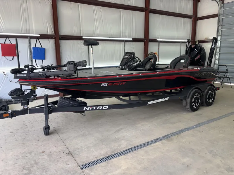 Slide: The Image of 2024 Nitro Z20 Pro bass boat in a garage, featuring sleek black and red design. - 3