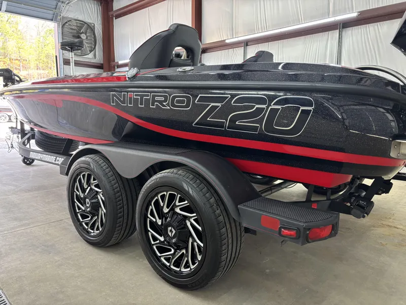 Slide: The Image of 2024 Nitro Z20 Pro boat with sleek design and dual axle trailer in a garage. - 9