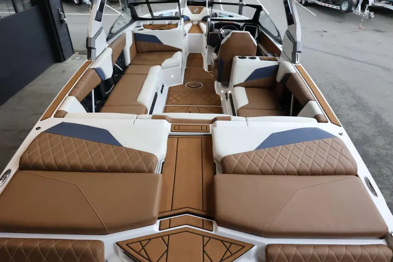 Slide: The Image of 2021 Tigé Z3 boat interior with luxurious brown and white seating, modern design. - 11