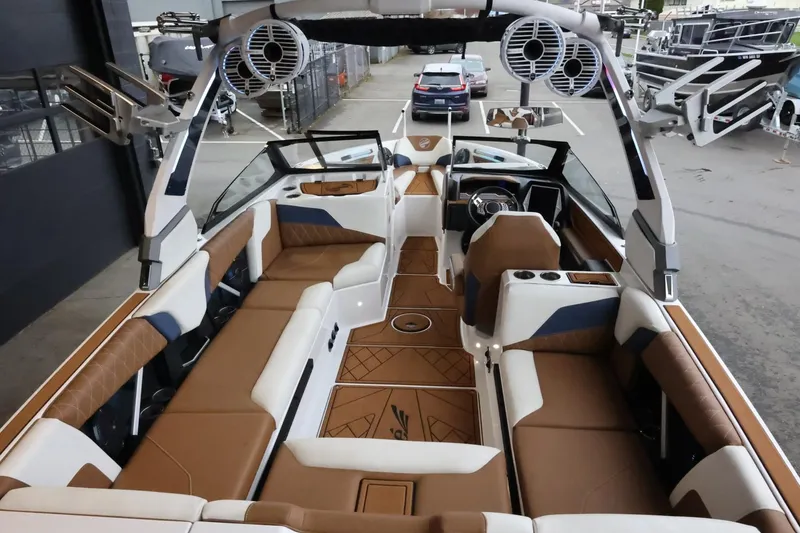 Slide: The Image of 2021 Tigé Z3 boat interior with brown and white seating, advanced audio system, and sleek design. - 12