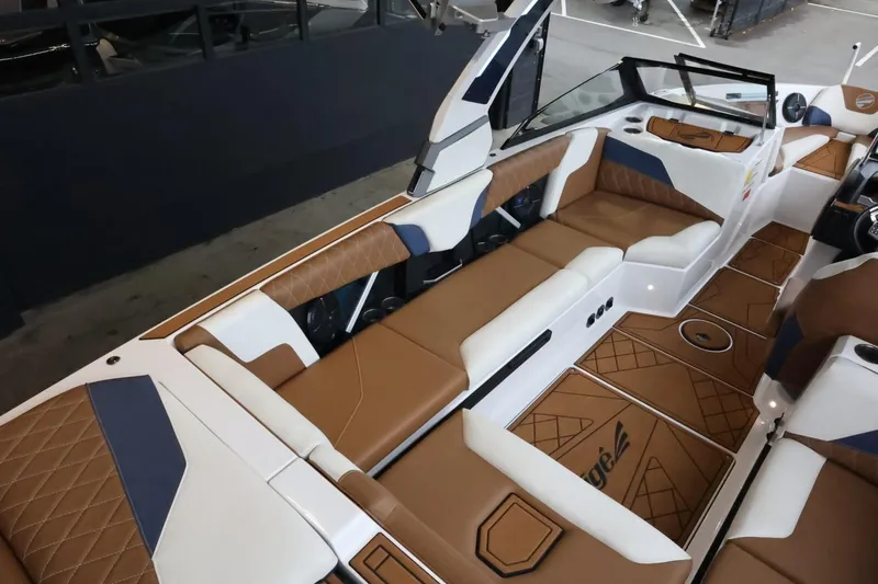 Slide: The Image of 2021 Tigé Z3 boat interior with brown and white seating, modern design. - 13