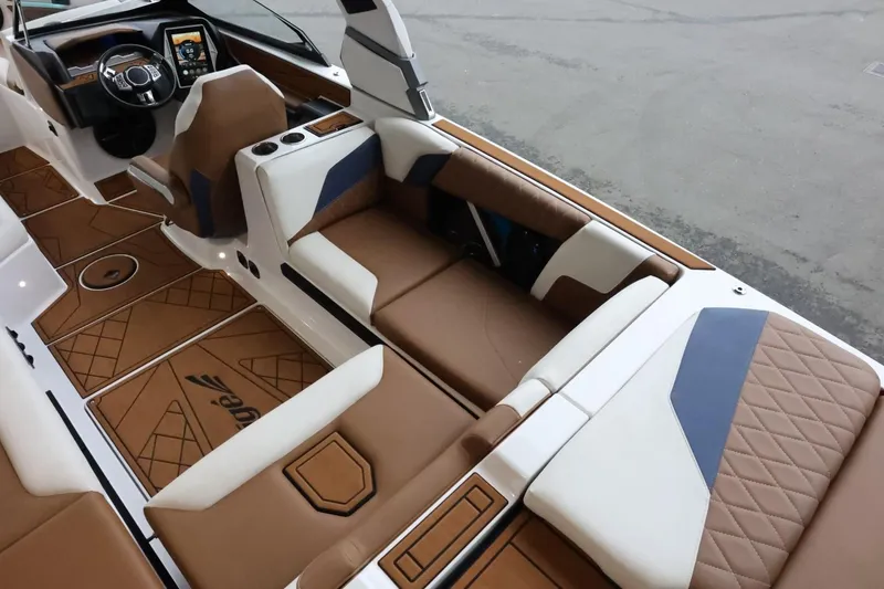 Slide: The Image of 2021 Tigé Z3 boat interior with brown and white leather seating, modern dashboard. - 14