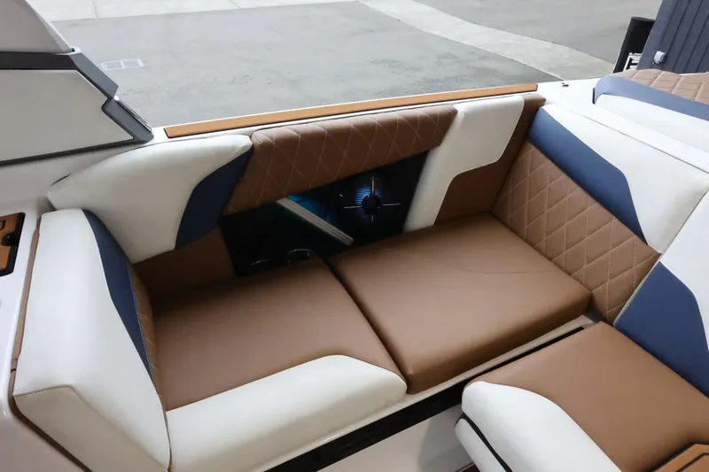 Slide: The Image of 2021 Tigé Z3 boat interior with brown and white cushioned seating. - 15