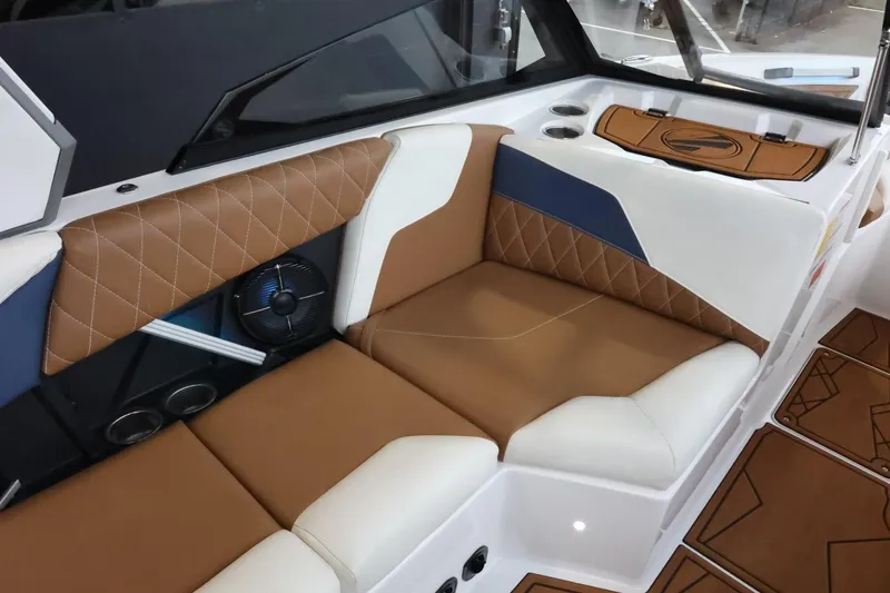 Slide: The Image of 2021 Tigé Z3 boat interior with brown and white leather seating, diamond stitching, and modern design. - 17