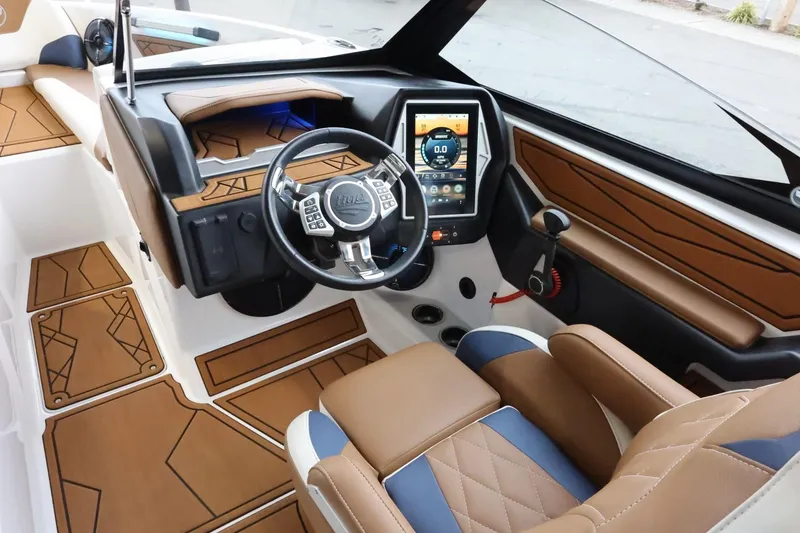 Slide: The Image of 2021 Tigé Z3 boat interior with modern dashboard and luxurious seating. - 18
