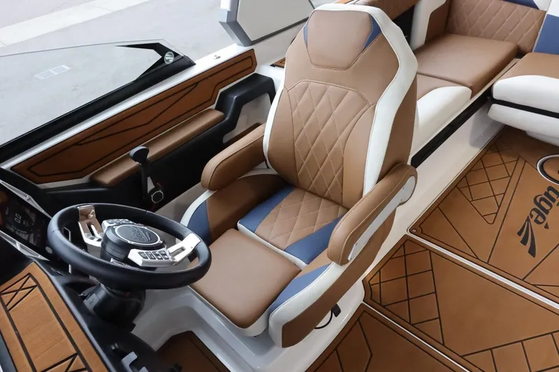 Slide: The Image of 2021 Tigé Z3 boat interior with luxurious brown and white seating and modern steering wheel. - 19