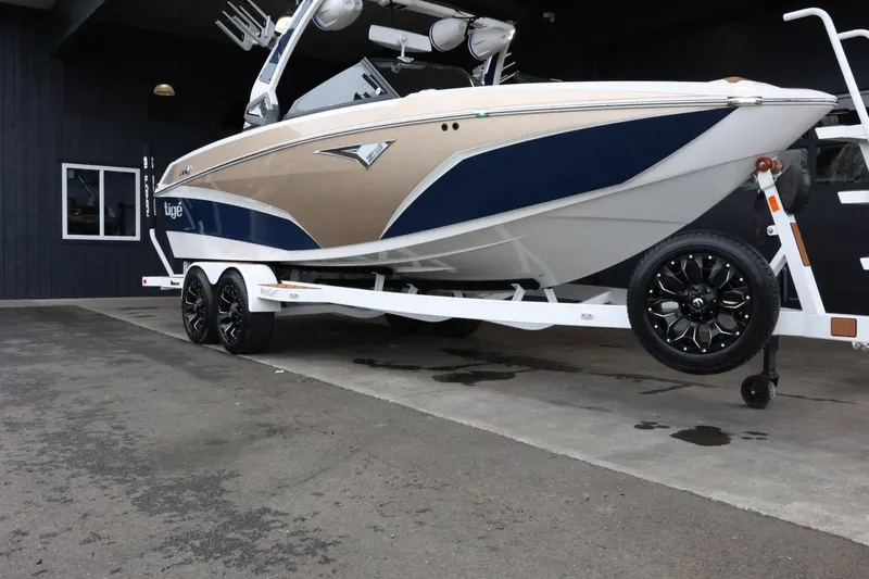 Slide: The Image of 2021 Tigé Z3 boat on trailer, featuring sleek design and dual-tone color scheme. - 2