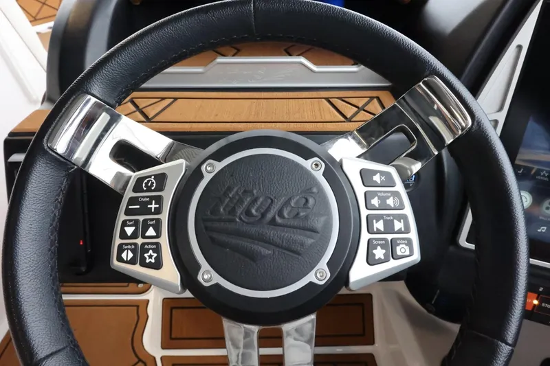 Slide: The Image of Steering wheel of 2021 Tigé Z3 boat with control buttons and sleek design. - 20