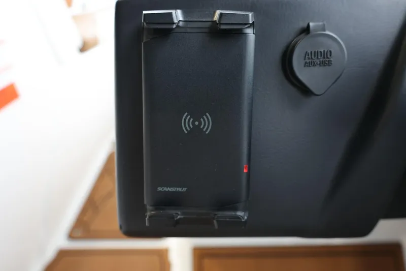 Slide: The Image of 2021 Tigé Z3 dashboard with wireless charging pad and audio accessory port. - 27