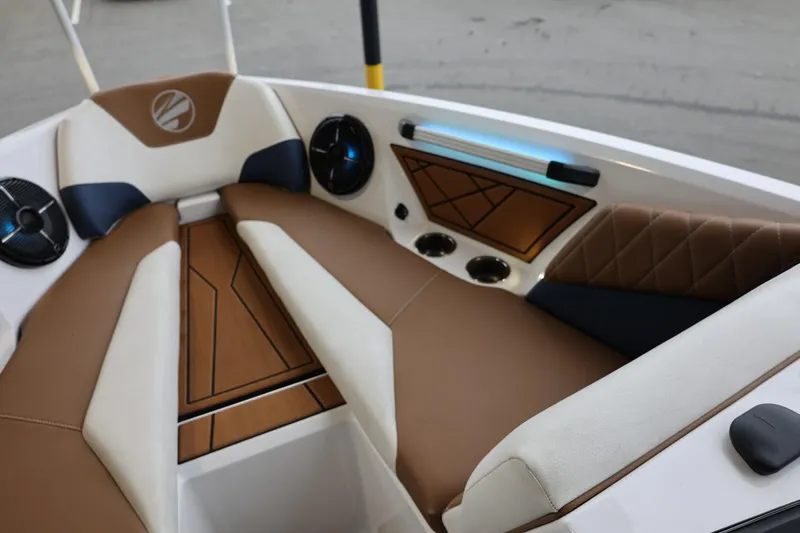 Slide: The Image of 2021 Tigé Z3 boat interior with brown and white seating, modern design, and audio system. - 30