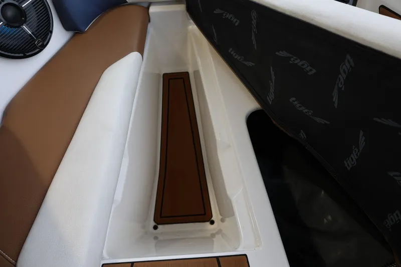 Slide: The Image of 2021 Tigé Z3 boat interior with brown and white seating and speaker detail. - 33