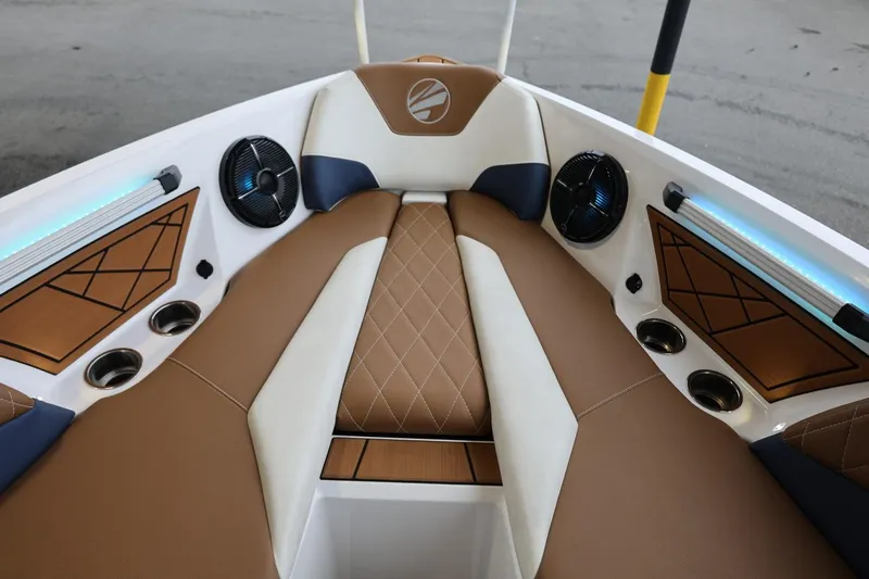 Slide: The Image of 2021 Tigé Z3 boat interior with brown and white seating, speakers, and cup holders. - 34