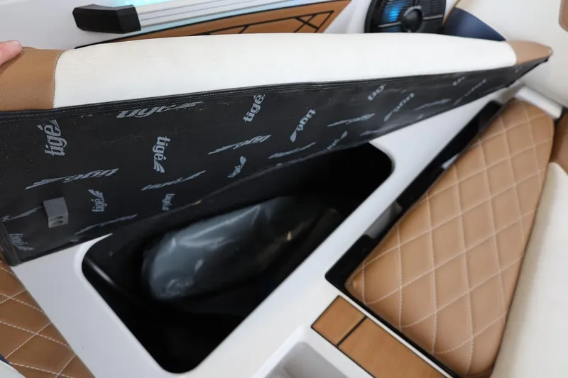 Slide: The Image of 2021 Tigé Z3 boat interior storage compartment with tan quilted seats. - 35