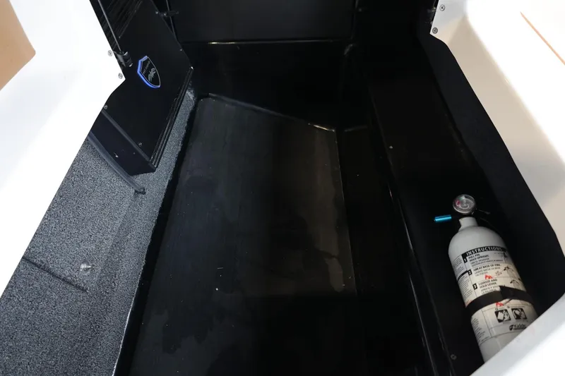 Slide: The Image of Interior storage compartment of a 2021 Tigé Z3 boat with fire extinguisher. - 46