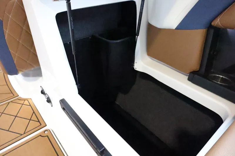Slide: The Image of 2021 Tigé Z3 boat interior storage compartment with brown and blue seating. - 48