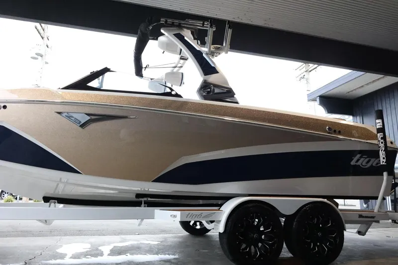 Slide: The Image of 2021 Tigé Z3 boat on trailer, sleek design with gold and blue accents. - 5