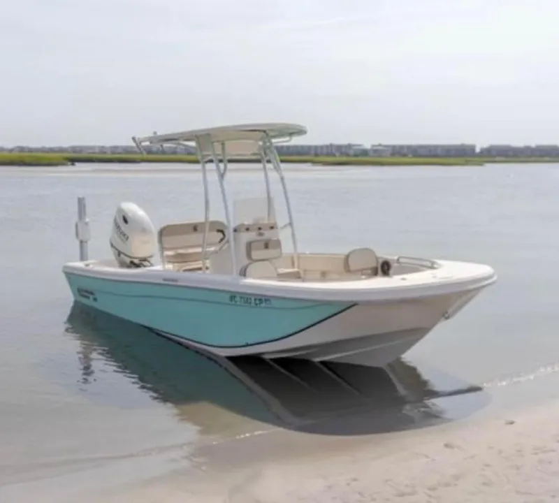 Slide: The Image of 2020 Carolina Skiff 21 Ultra Elite boat docked on a sandy shore. - 10