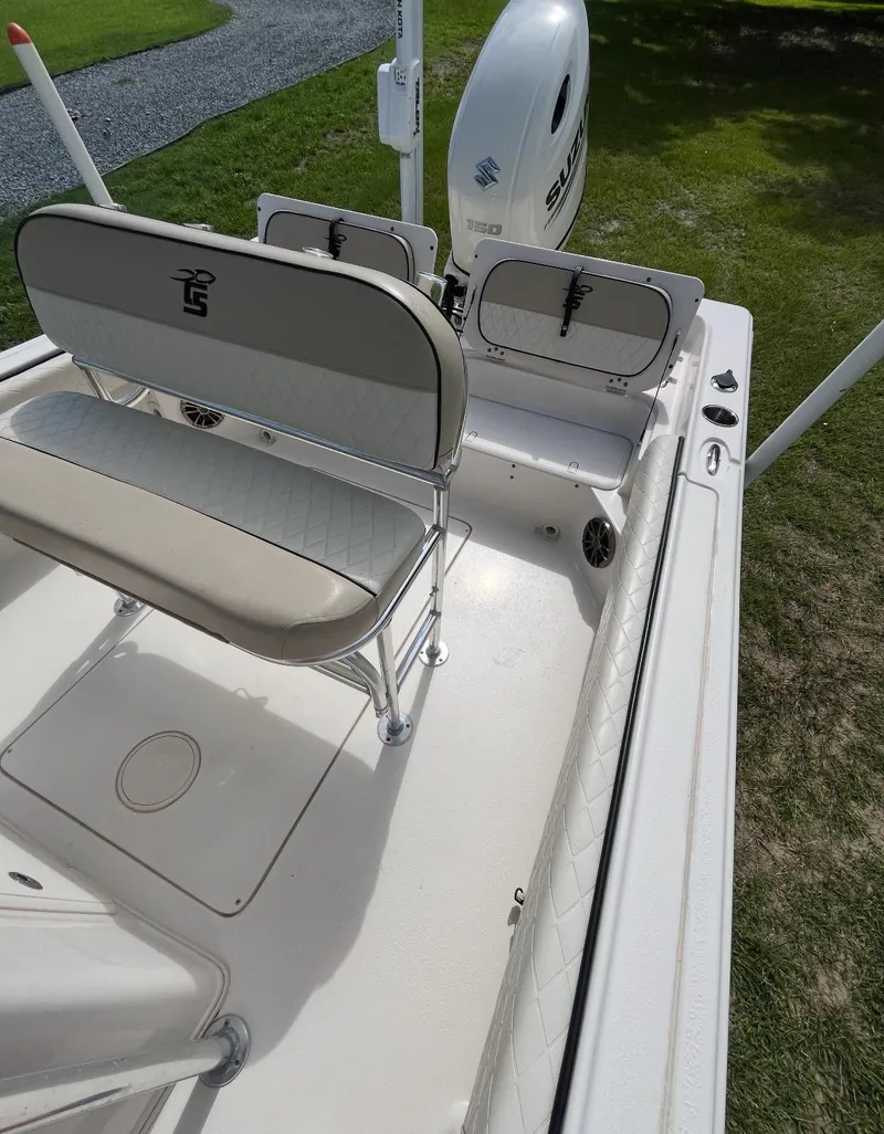 Slide: The Image of 2020 Carolina Skiff 21 Ultra Elite boat interior with seating and motor. - 14