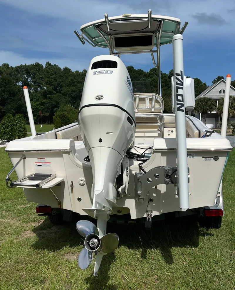 Slide: The Image of 2020 Carolina Skiff 21 Ultra Elite boat with outboard motor, parked on grass. - 19