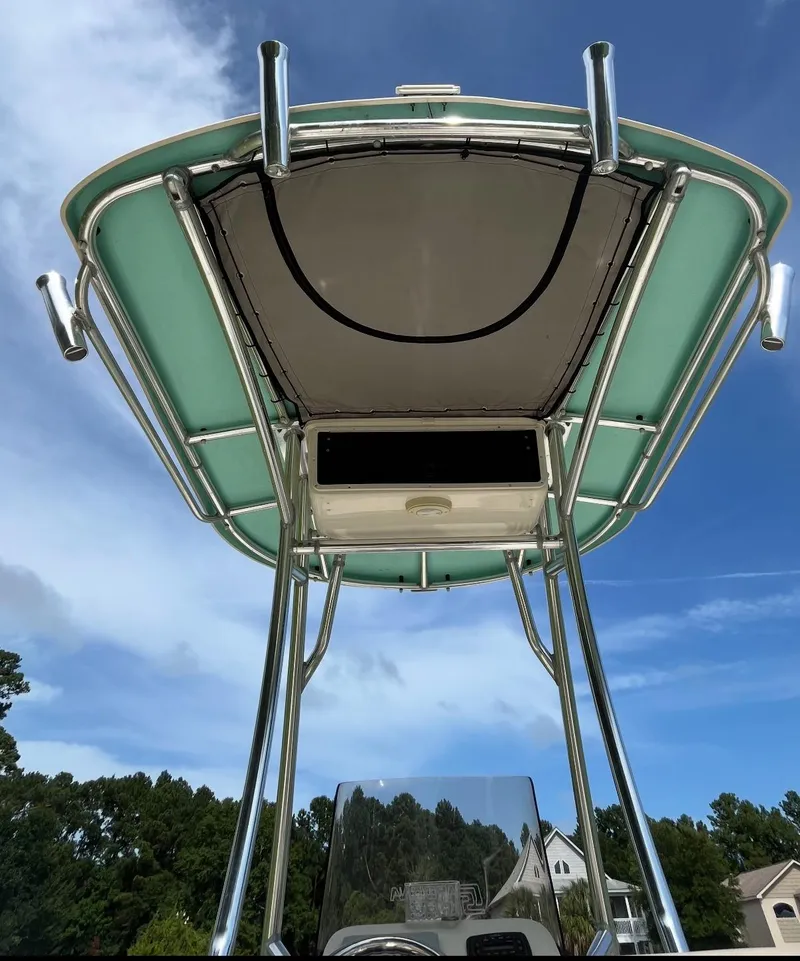 Slide: The Image of 2020 Carolina Skiff 21 Ultra Elite boat with T-top against blue sky. - 20