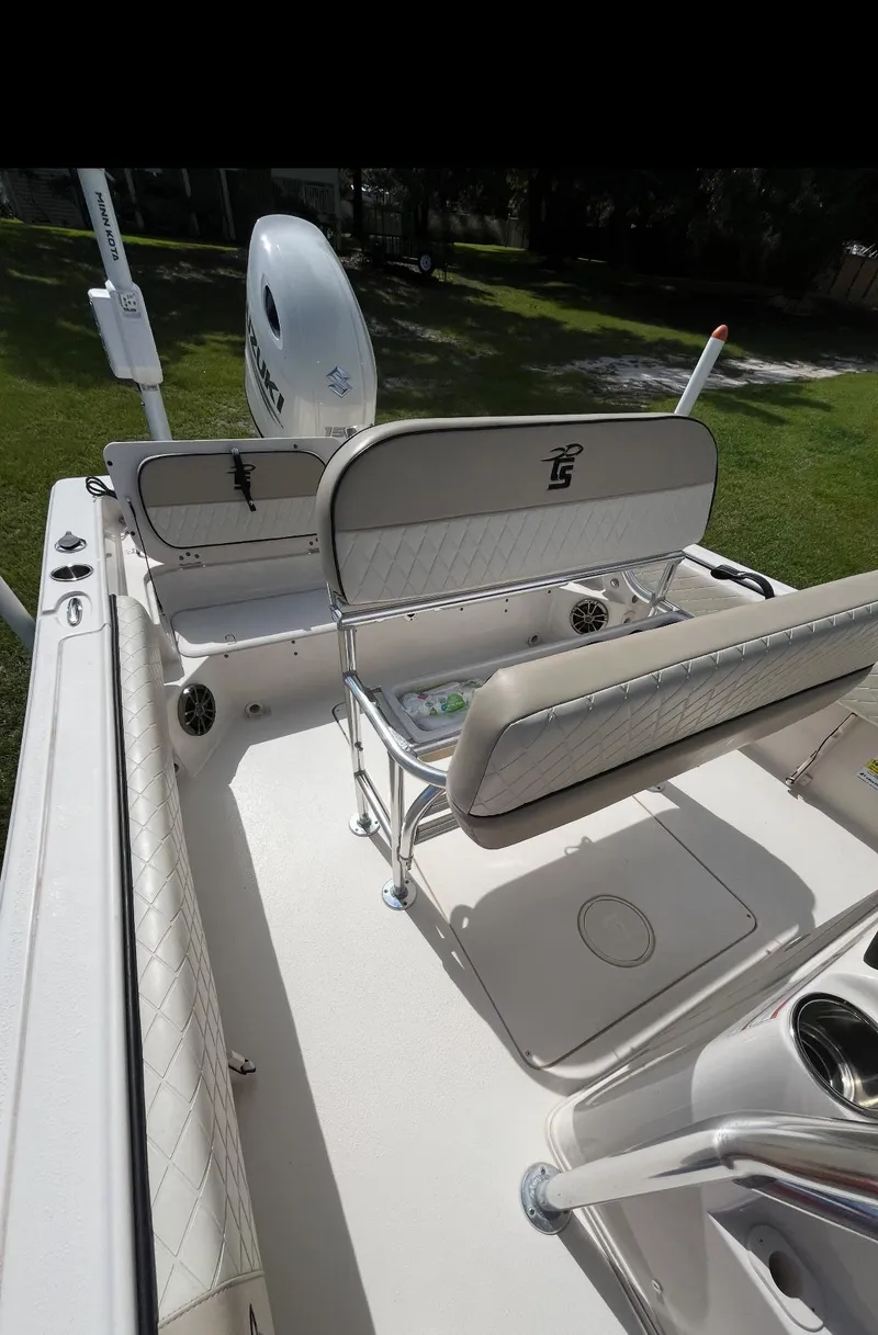 Slide: The Image of 2020 Carolina Skiff 21 Ultra Elite boat interior with seating and motor on calm water. - 7