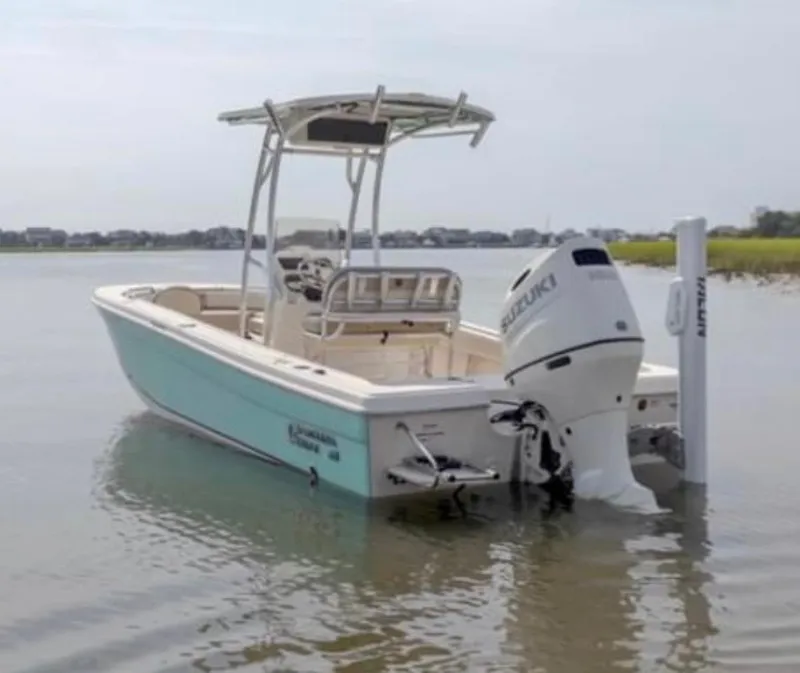 Slide: The Image of 2020 Carolina Skiff 21 Ultra Elite boat with Suzuki outboard motor on calm water. - 8
