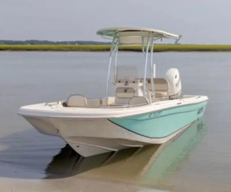 Slide: The Image of 2020 Carolina Skiff 21 Ultra Elite boat on calm water, featuring a sleek design. - 9