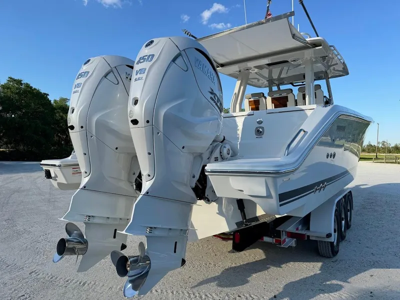 Slide: The Image of 2024 Pursuit S 358 Sport boat with dual outboard engines on a trailer. - 21