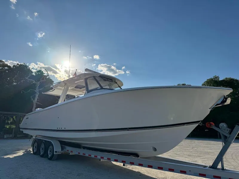 Slide: The Image of 2024 Pursuit S 358 Sport boat on trailer under clear blue sky. - 4