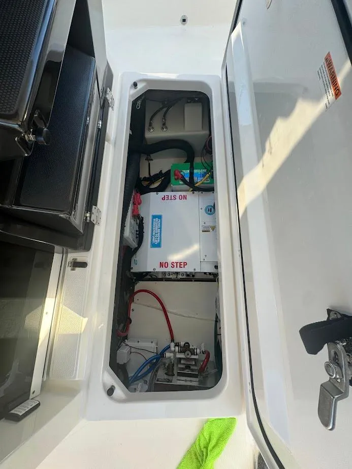 Slide: The Image of 2024 Pursuit S 358 Sport boat compartment with electrical components and wiring. - 46