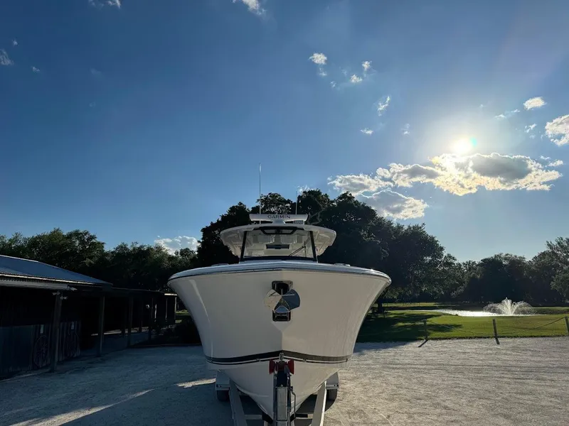 Slide: The Image of 2024 Pursuit S 358 Sport boat under clear blue sky with sun shining. - 6