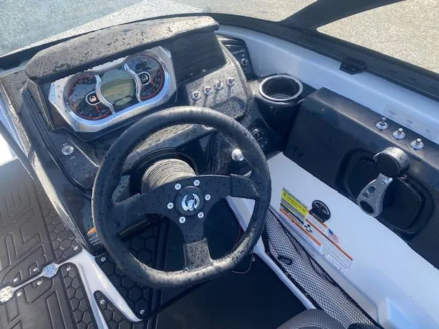 Slide: The Image of 2022 Scarab 195 ID boat dashboard with steering wheel and control panel. - 18