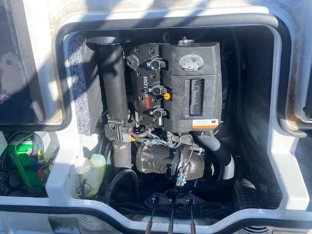 Slide: The Image of Engine compartment of a 2022 Scarab 195 ID boat, showcasing internal components. - 23