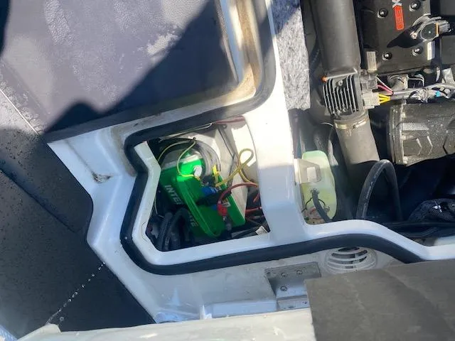 Slide: The Image of Engine compartment of a 2022 Scarab 195 ID boat, showing battery and wiring. - 24