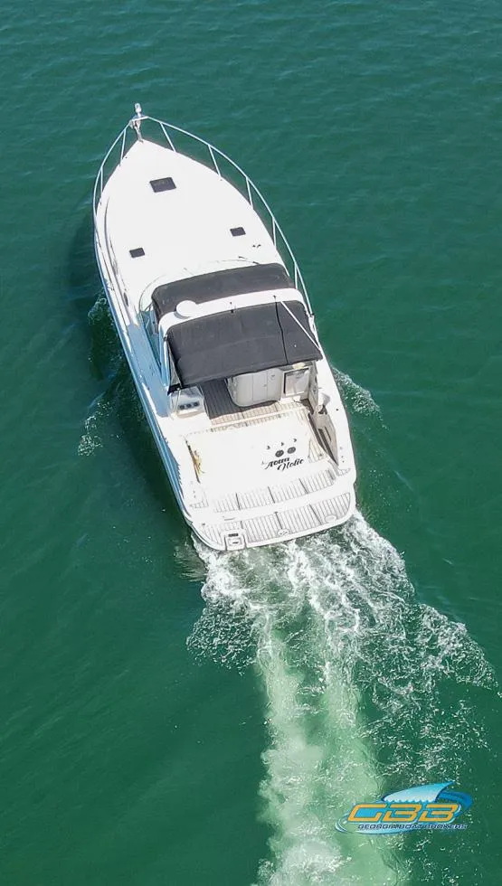 Slide: The Image of 2000 Rinker 340 Express Cruiser navigating on clear blue water. - 13