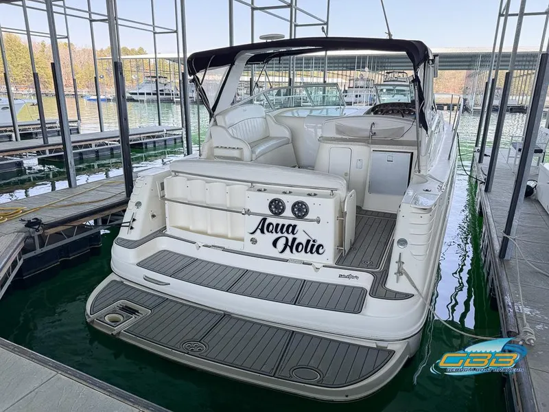 Slide: The Image of 2000 Rinker 340 Express Cruiser docked, rear view with "Aqua Holic" name visible. - 14