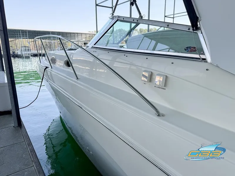 Slide: The Image of 2000 Rinker 340 Express Cruiser docked at marina, side view. - 16