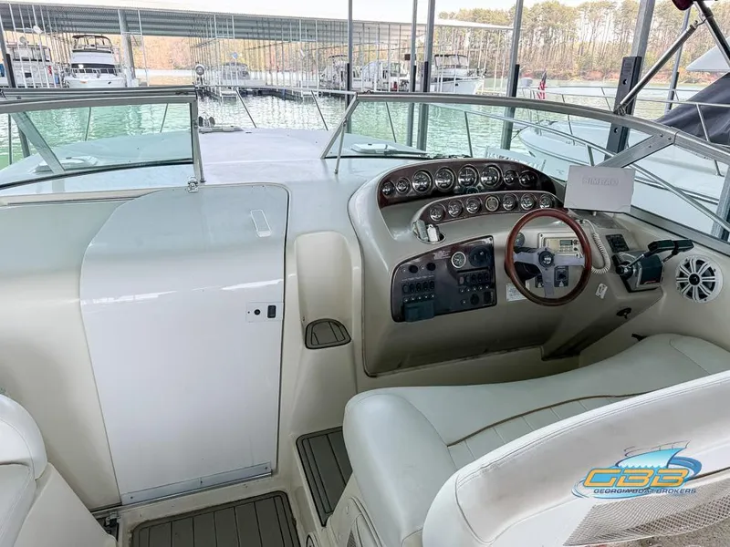 Slide: The Image of 2000 Rinker 340 Express Cruiser cockpit with steering wheel and control panel. - 17